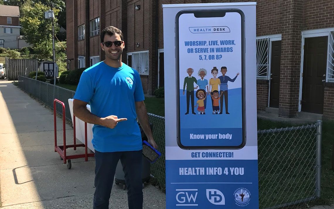 Man outside standing next to a pop up display