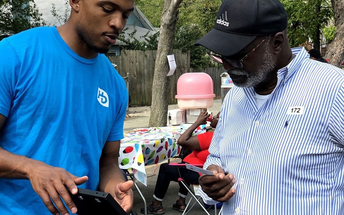 A volunteer speaking with a participant 